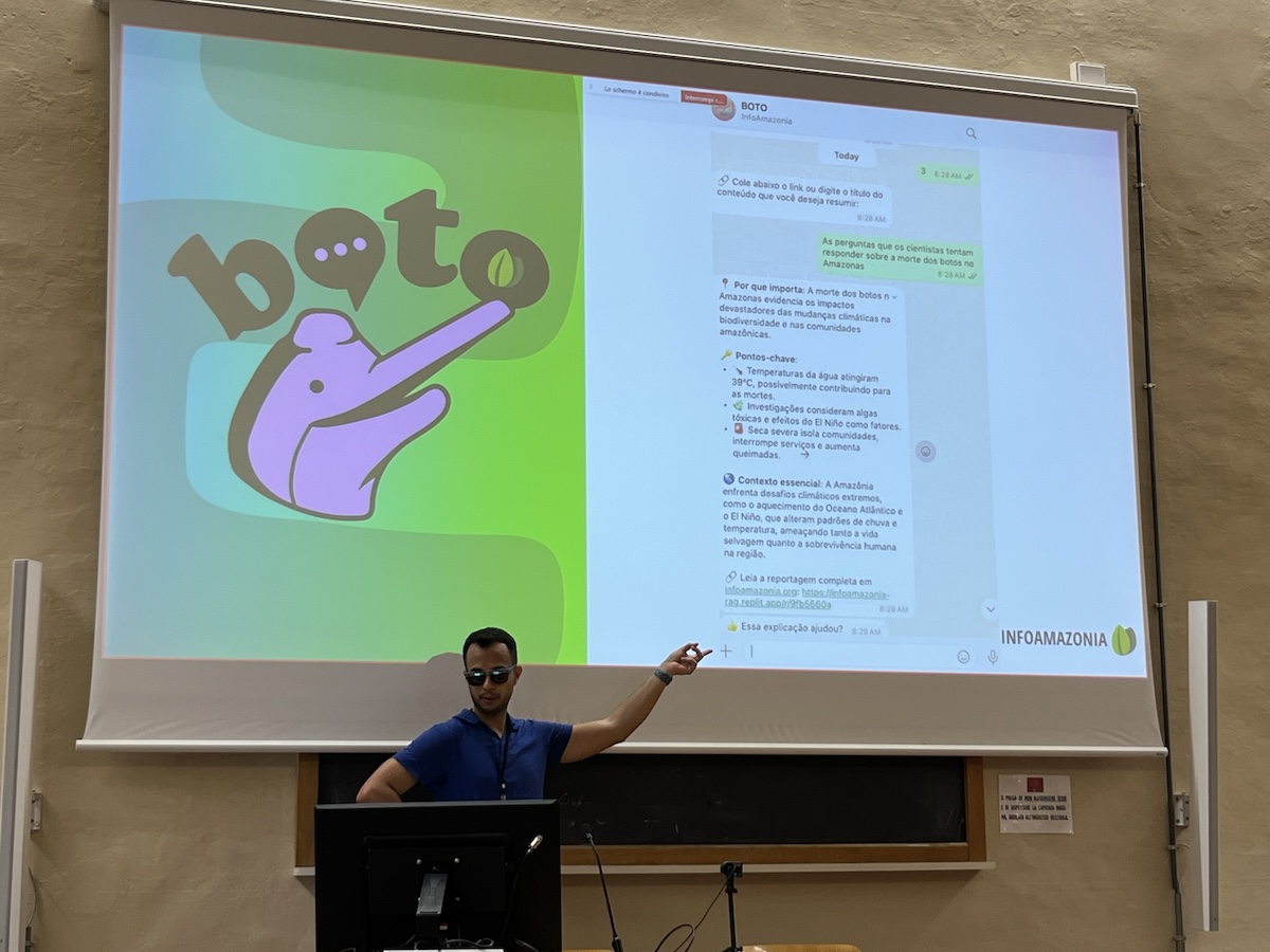 a man in sunglasses standing in front of a projector showing a logo and whatsapp messages