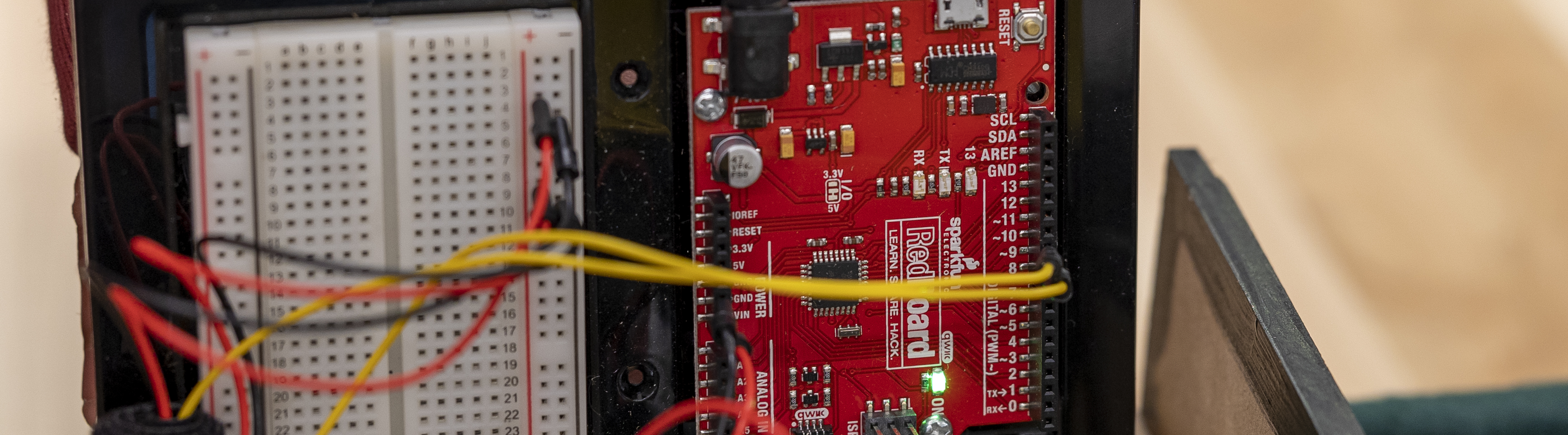 an arduino and breadboard with wires coming out of it