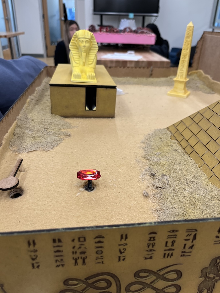 closeup of sphinx obstacle with a gem you have to hit with marble to open hole