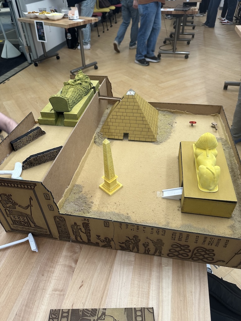 top view of mini mini golf hole colored brown, with a pyramid and a sphinx obstacle