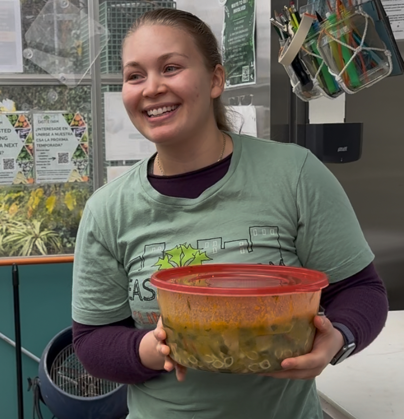Woman holding a container of soup
