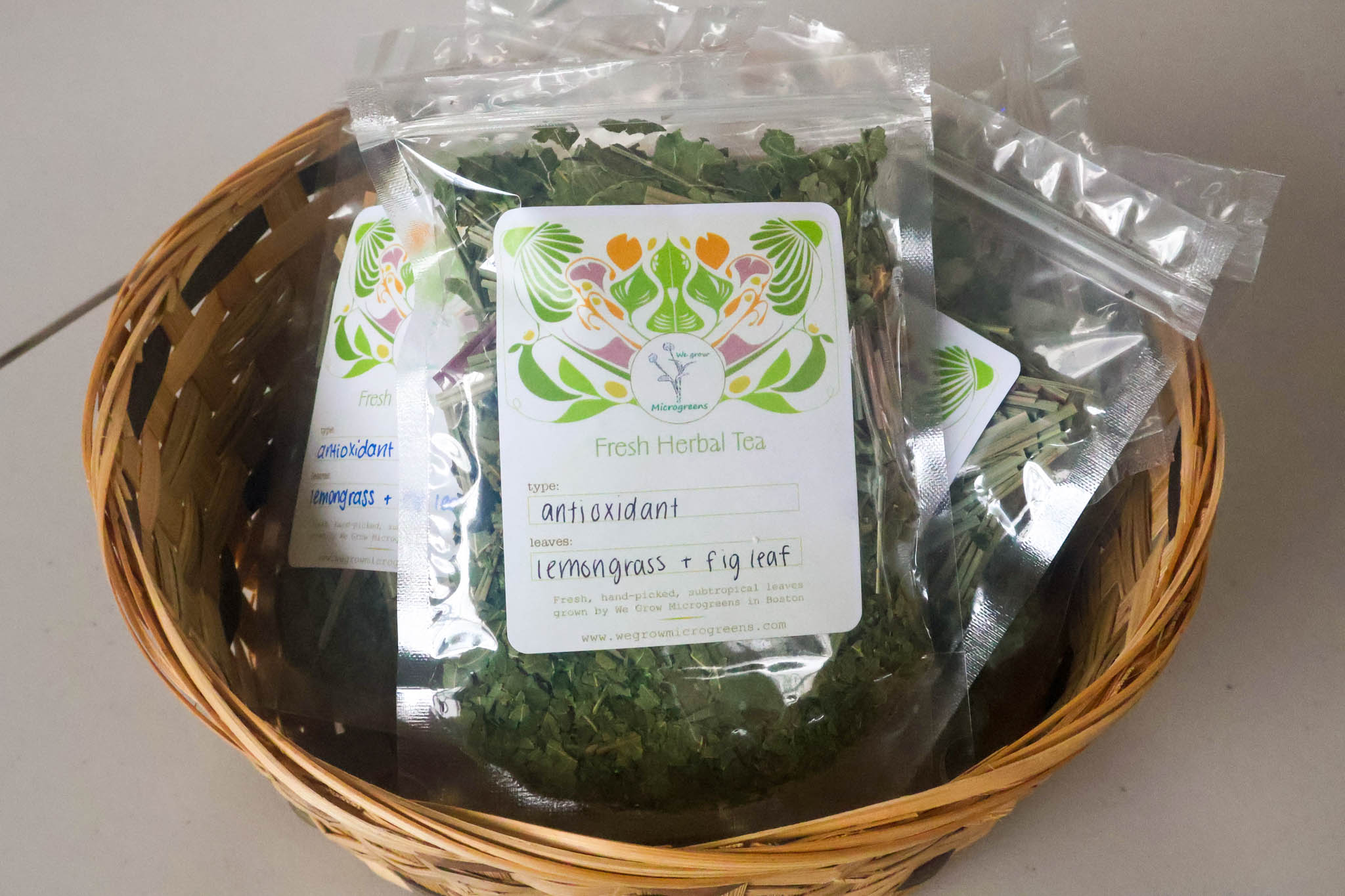 A close-up of We Grow Microgreens' signature herbal tea packaging.